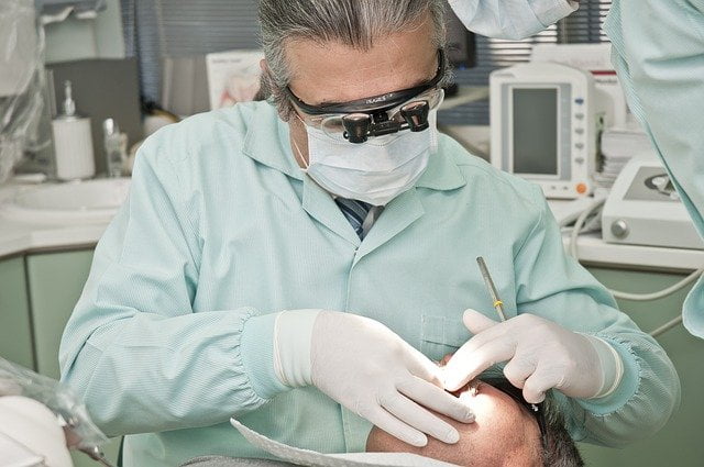 dentist looking at teeth